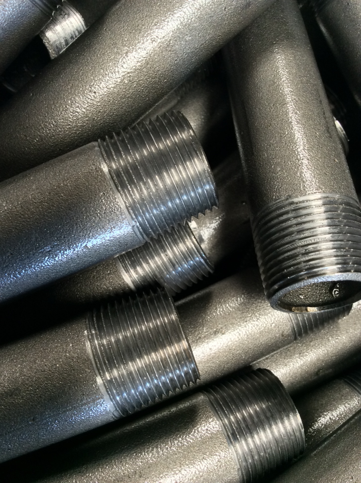 Steel pipe nipples — close-up of threaded ends